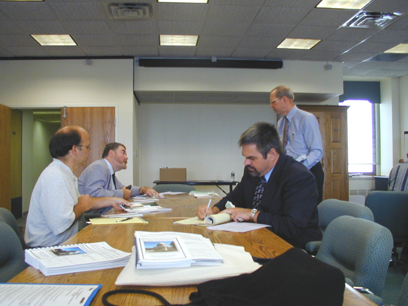 The Development Office's Bob Henrich (standing) coordinates meetings with state business representatives. The Purchasing Division has been involved in these meetings.