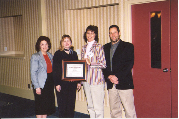 Tax's Syble Atkins was our 2003 Agency Procurement Officer of the Year (pictured next to Purchasing Director Dave Tincher). Pictured are her super-visor Patricia Haddy (far left) and Tax Commissioner Rebecca Melton Craig (next to Atkins), who made a special trip to Morgantown for the announcement.