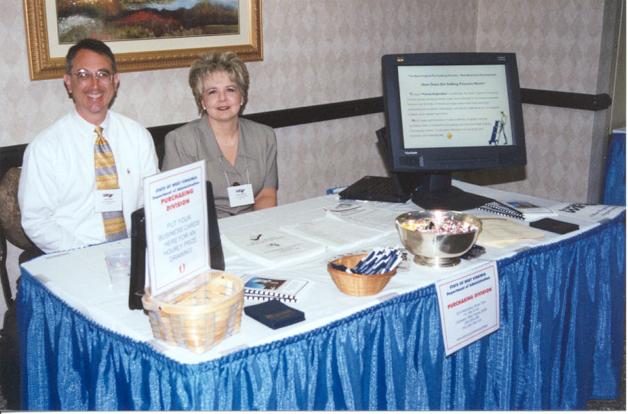 Scott Padon and Debbie Watkins are pictured at the Purchasing Division's booth during the Teaming to Win exhibits. Purchasing Director Dave Tincher conducted one-on-one counseling sessions with vendors.